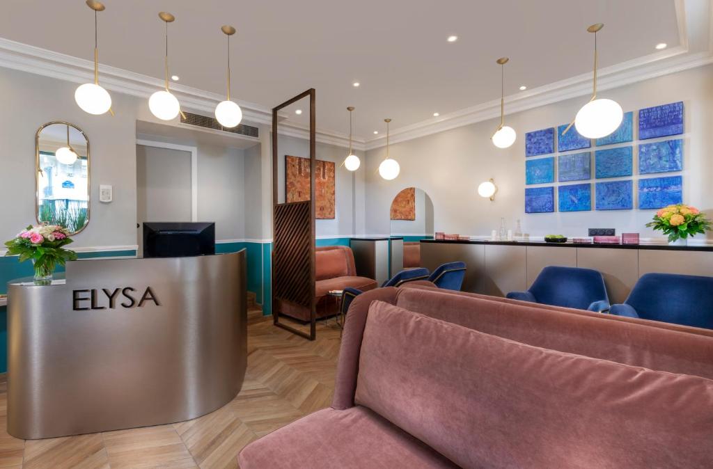 a waiting room with chairs and a reception desk at Hotel Elysa-Luxembourg in Paris