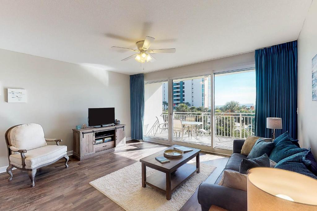 a living room with a couch and a tv at Sterling Shores in Destin