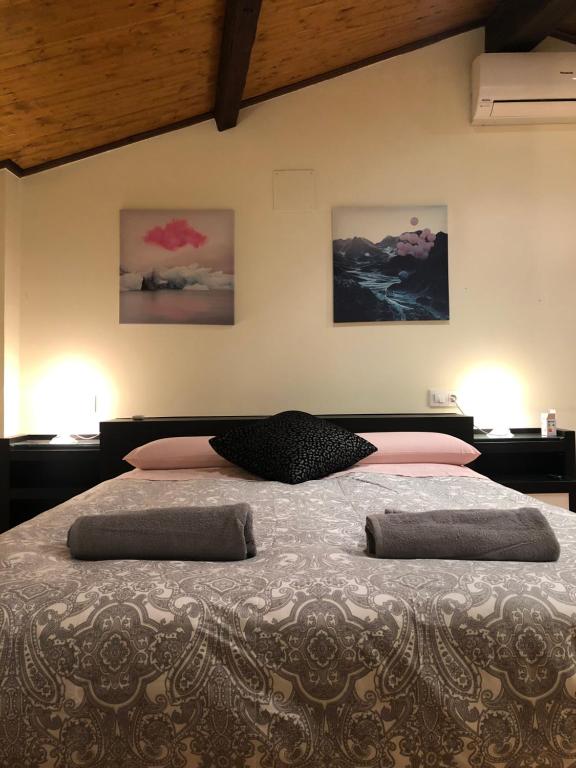 a bedroom with a bed with two pillows on it at Casa Confort Cuenca in Cuenca
