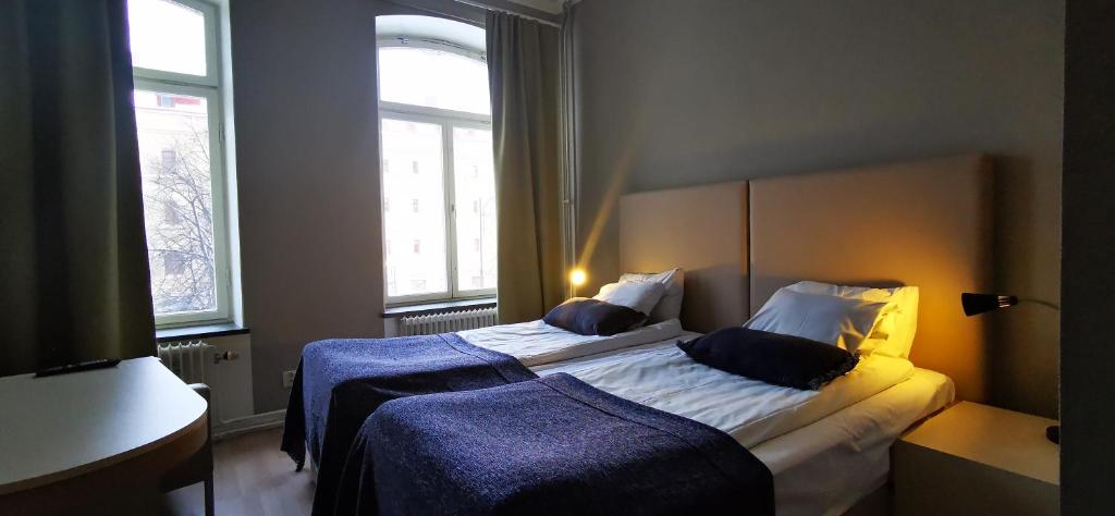 Postel nebo postele na pokoji v ubytování Sundsvall City Hotel