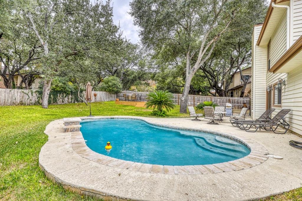 a swimming pool with a toy duck in a yard at Chic Poolside Paradise in San Antonio