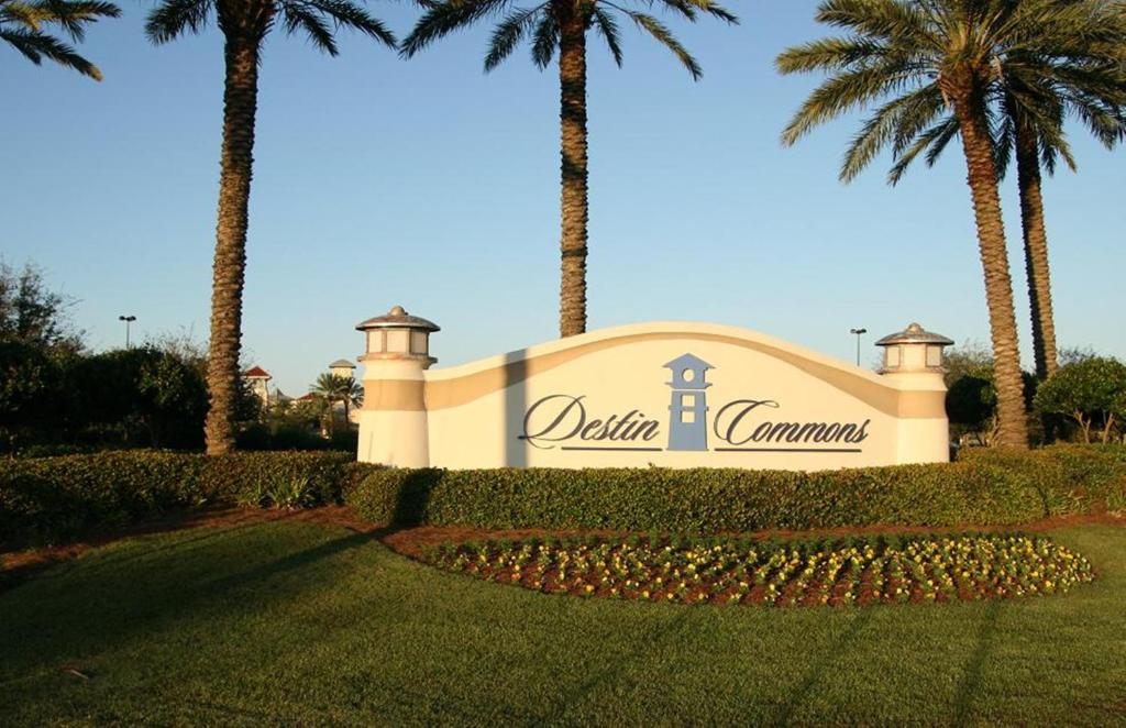 a sign for a hotel with palm trees in the background at Holiday Inn Express Destin E - Commons Mall Area by IHG in Destin