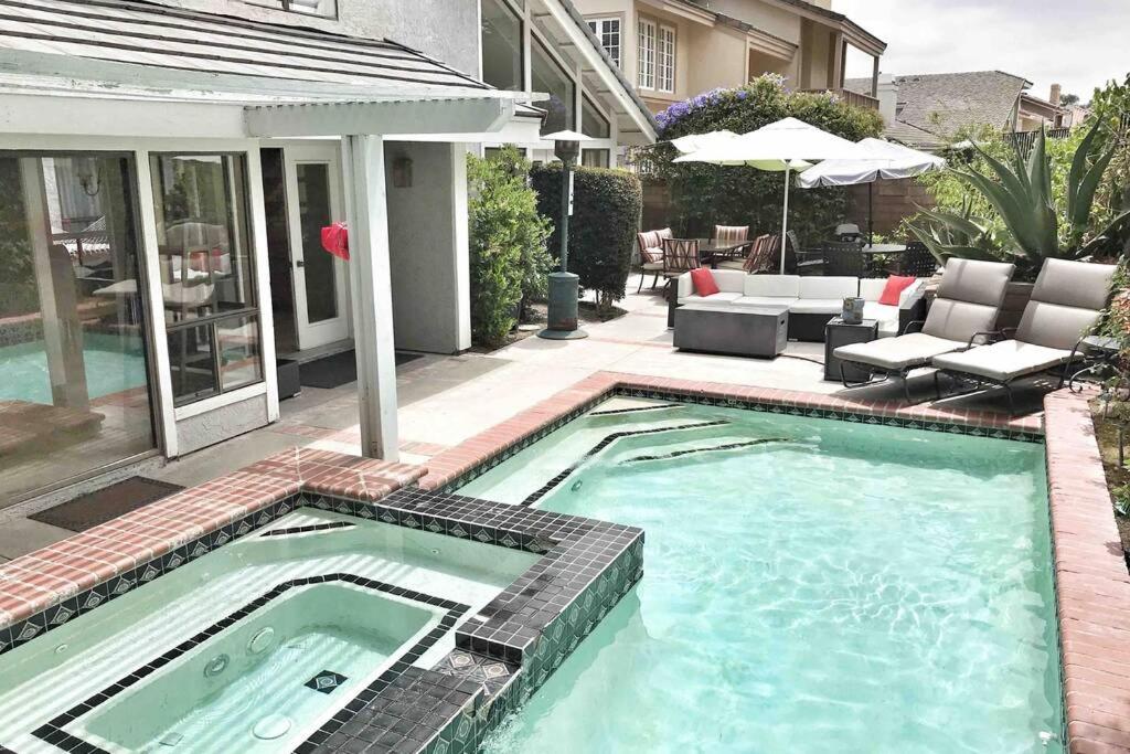 a swimming pool in front of a house at Stunning home near lake in Mission Viejo