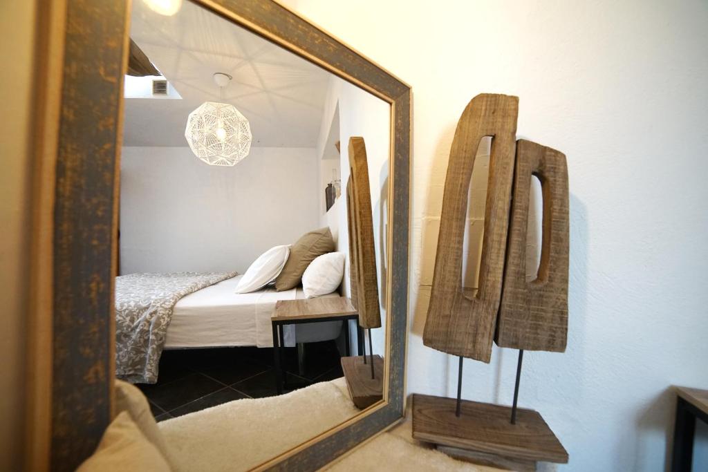 a mirror reflecting a bedroom with a bed in a room at B&B La Mimosa in Teguise