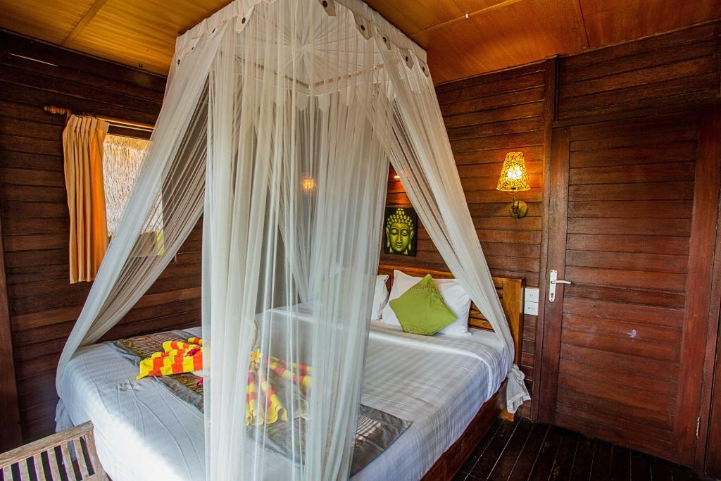 Postel nebo postele na pokoji v ubytování Nanuk's Bungalows