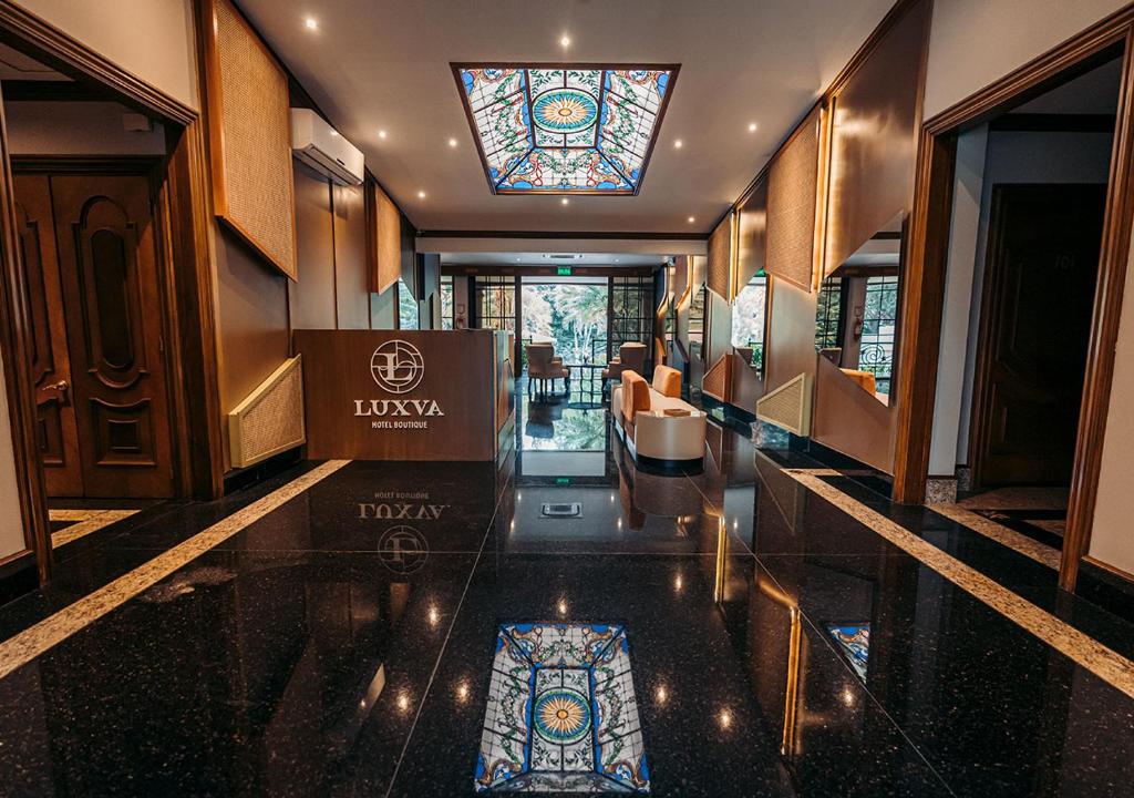 a lobby with a stained glass window and a building at Luxva Hotel Boutique in Guayaquil