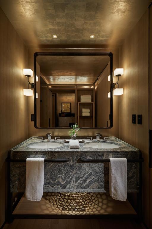 a bathroom with a large mirror and a sink at Park Hyatt Kyoto in Kyoto
