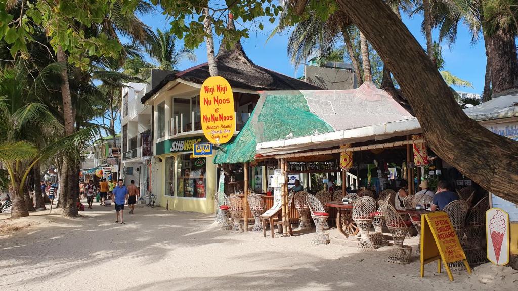 eine Straße mit einem Restaurant mit Tischen und Stühlen in der Unterkunft Nigi Nigi Nu Noos 'e' Nu Nu Noos in Boracay