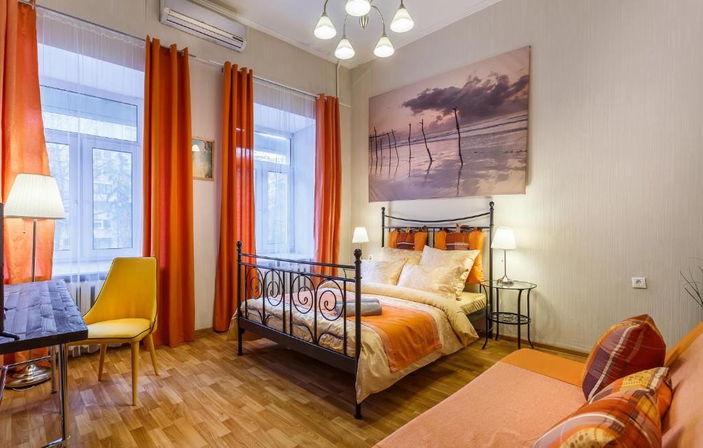 a bedroom with a bed and a painting on the wall at Апартаменты на Тверской in Moscow