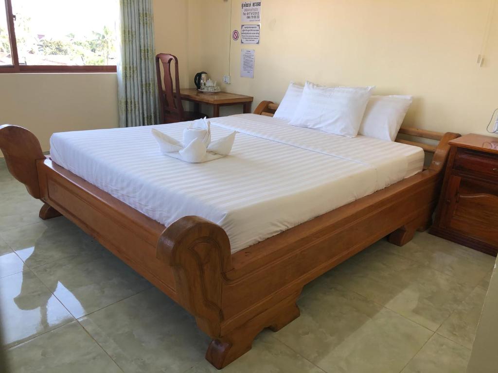 En eller flere senge i et værelse på Savet Guesthouse