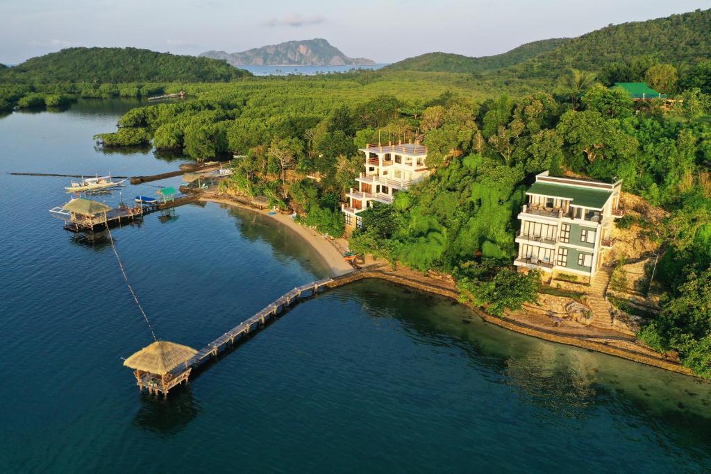 an aerial view of a body of water with a dock at La Estancia Busuanga in Busuanga