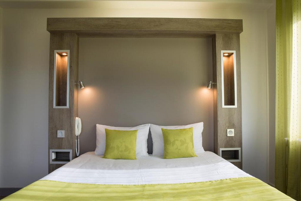 Postel nebo postele na pokoji v ubytování Hotel Les Mésanges