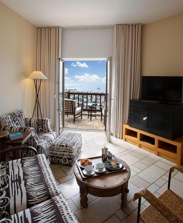 a living room with a couch and a table at The Marmara Bodrum - Adult Only in Bodrum City