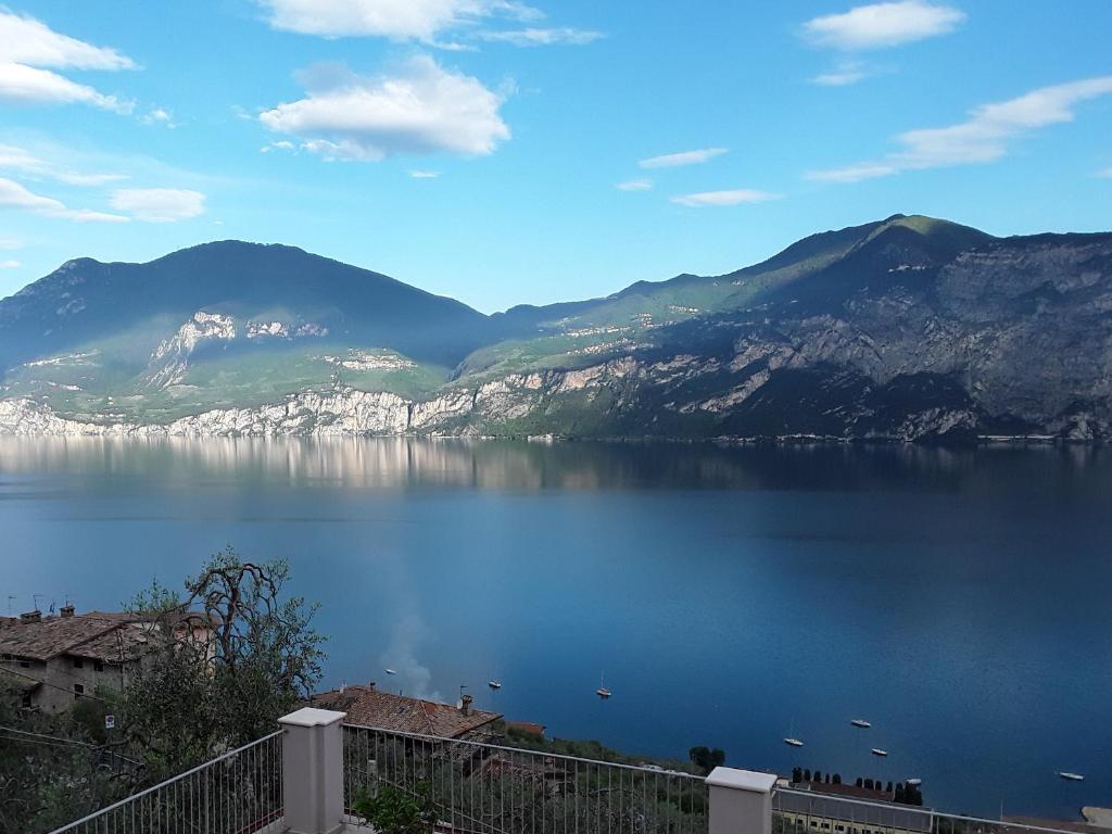 a view of a large body of water with mountains at Casa Punta Veleno in Brenzone sul Garda
