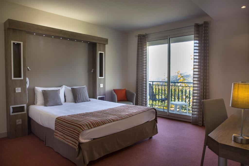 Postel nebo postele na pokoji v ubytování Hotel Les Mésanges