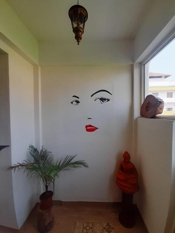 a wall with a painting of a woman on it at La Lune Fort Kochi in Cochin