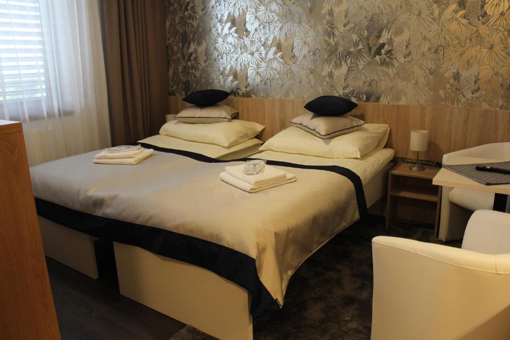 a hotel room with two beds and a chair at Apartments 461 in Modřice