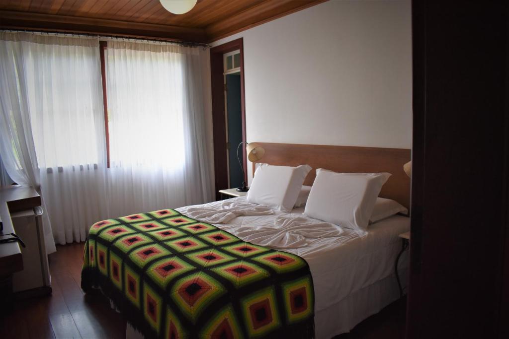 Postel nebo postele na pokoji v ubytování Hotel Pousada Arcádia Mineira