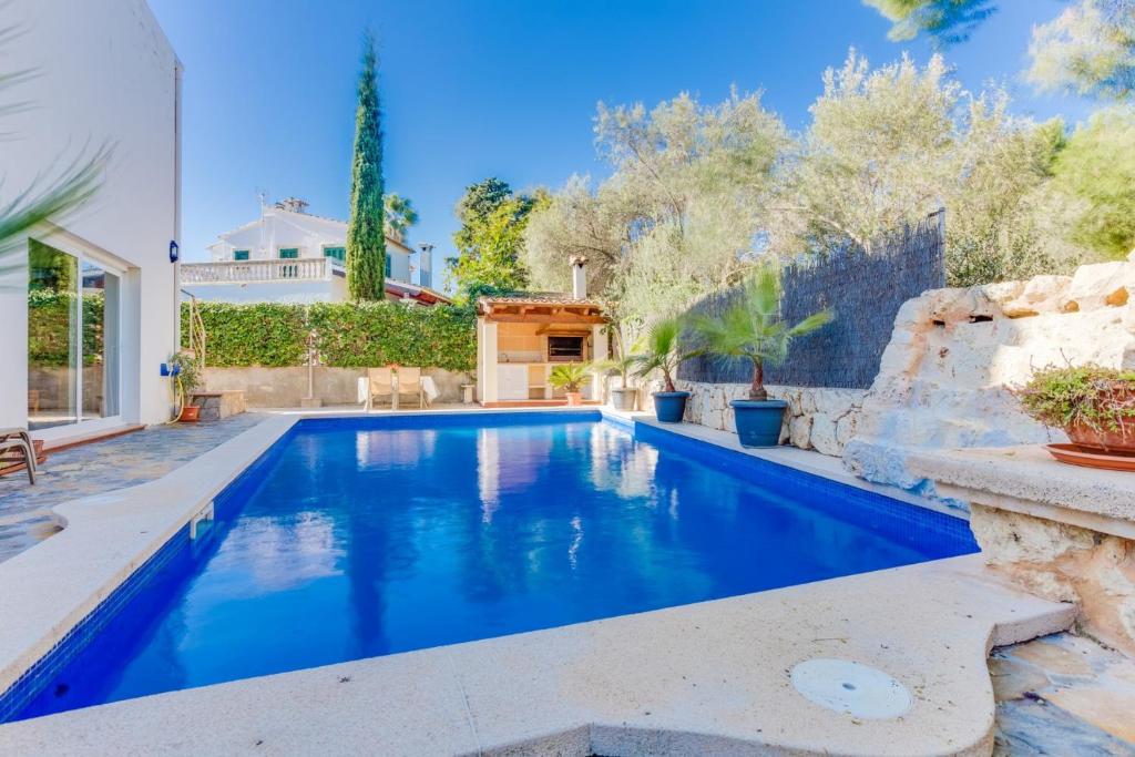 a swimming pool in the backyard of a villa at YupiHome Villa Ca S'Anglès in Alcudia