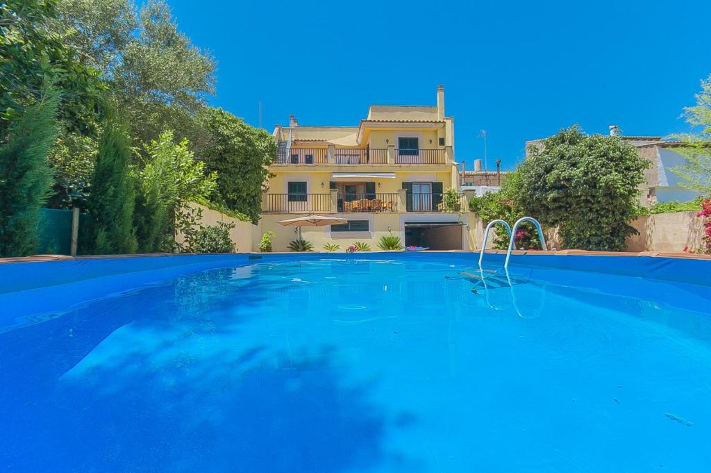 a large swimming pool in front of a house at Villa Clastra Maria in Maria de la Salut