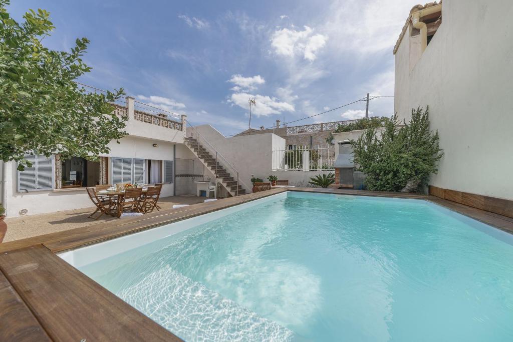 a swimming pool in the backyard of a house at CAsA SA MARINA in Alcudia