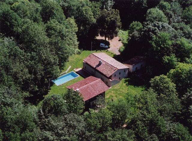 an aerial view of a house in the middle of a forest at Mas Masnou in Olot