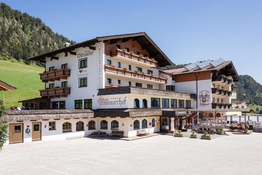 a large building in the middle of a courtyard at Hotel Wildauerhof in Walchsee