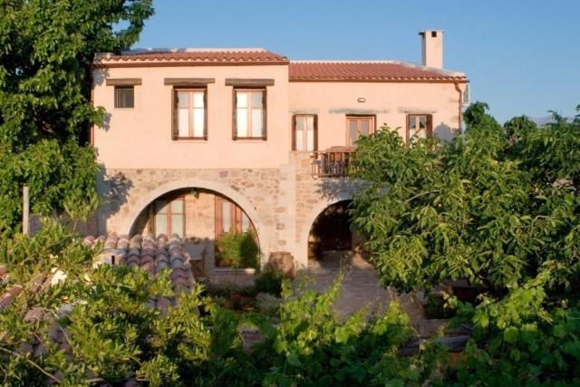 a large house with an arch in front of it at Sarris House in Xirokámbion