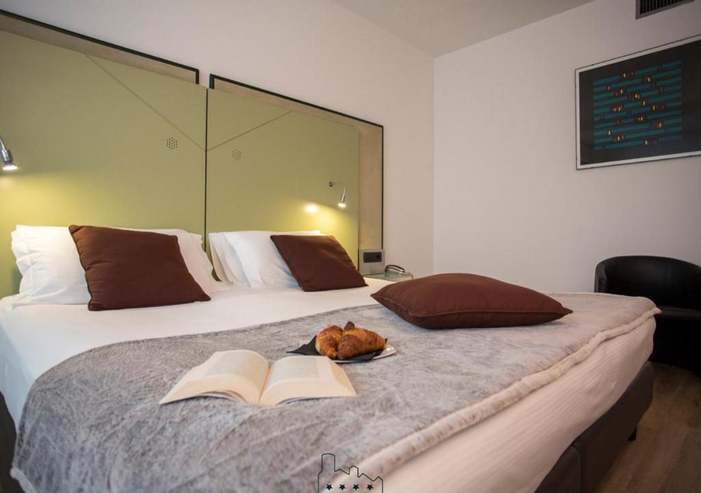 a bedroom with a bed, a desk, and a lamp at Hotel Buonconsiglio in Trento