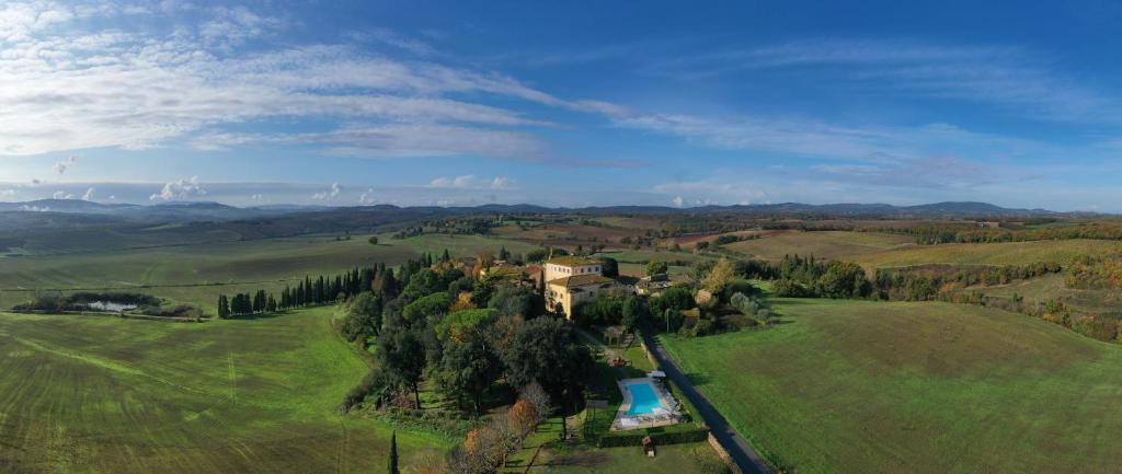 an aerial view of a house in a green field at Villa Sabolini in Colle Val D'Elsa