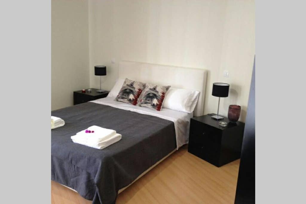 a bedroom with a bed with two night stands at Apartamento Varandas Soalheiras in Odeceixe