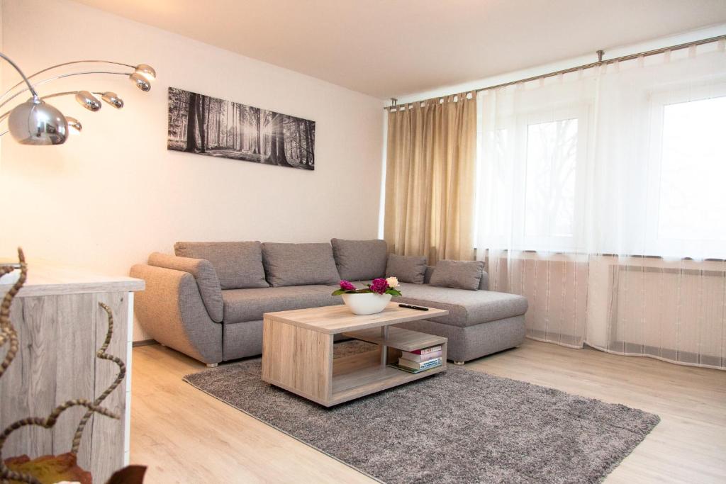 a living room with a couch and a table at T&K Apartments near Messe Fair Trade Düsseldorf und Airport 2B in Duisburg
