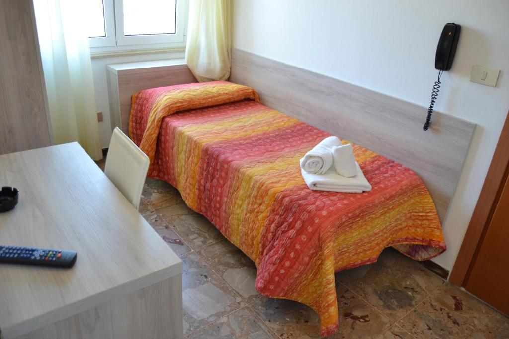Postel nebo postele na pokoji v ubytování Hotel Apis