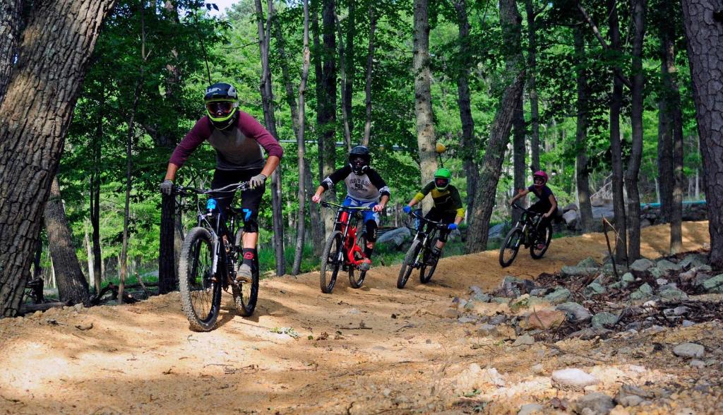 a group of people riding bikes on a dirt trail at Massanutten Resort by TripForth in McGaheysville
