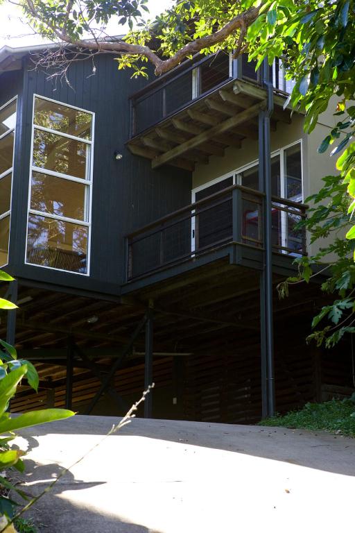 a black house with a balcony on the side of it at Billa Villa in Point Lookout