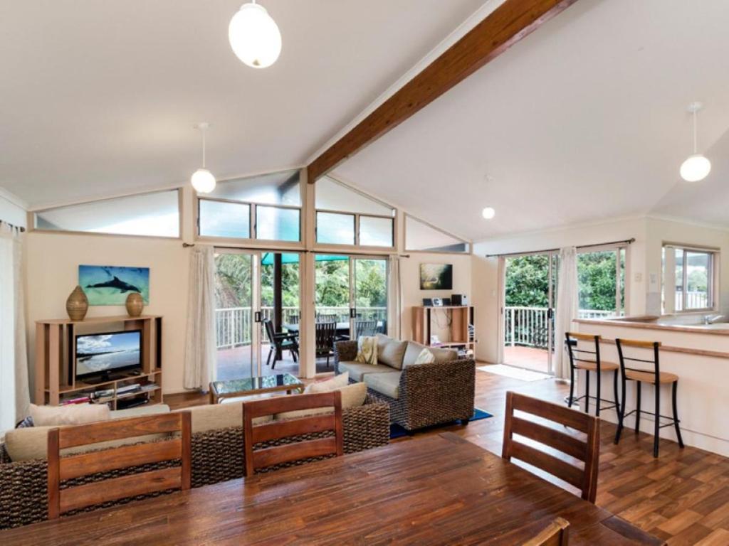 a living room with a couch and a table at Amaroo House in Point Lookout