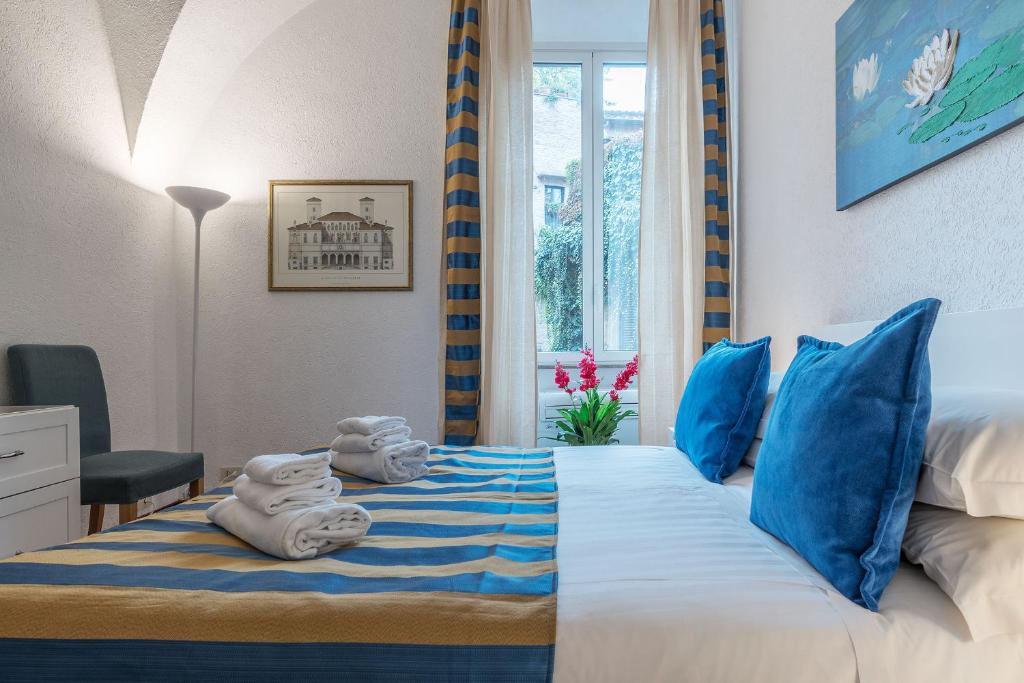 a bedroom with a bed with towels on it at CS Piazza Venezia Apartment in Rome