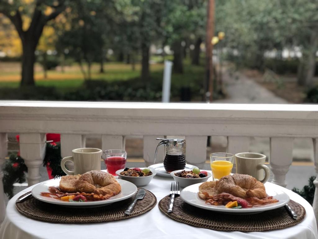 a table topped with plates of food and drinks at Forsyth Park Inn in Savannah