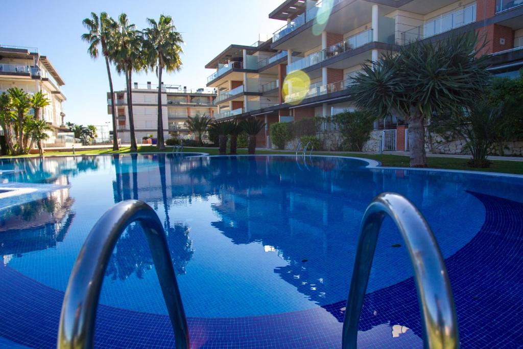 einem Pool vor einem Gebäude in der Unterkunft Apartamento nuevo en la playa- MET- Oliva Nova Golf in Oliva