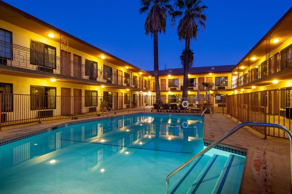 a pool in front of a hotel at night at Studio City Court Yard Hotel in Los Angeles