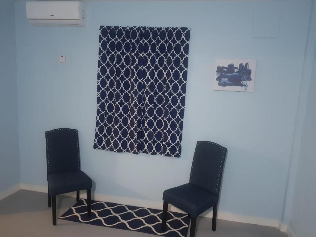 two chairs in a room with a picture on the wall at Careffe Suites Unit 4 in Cap Estate