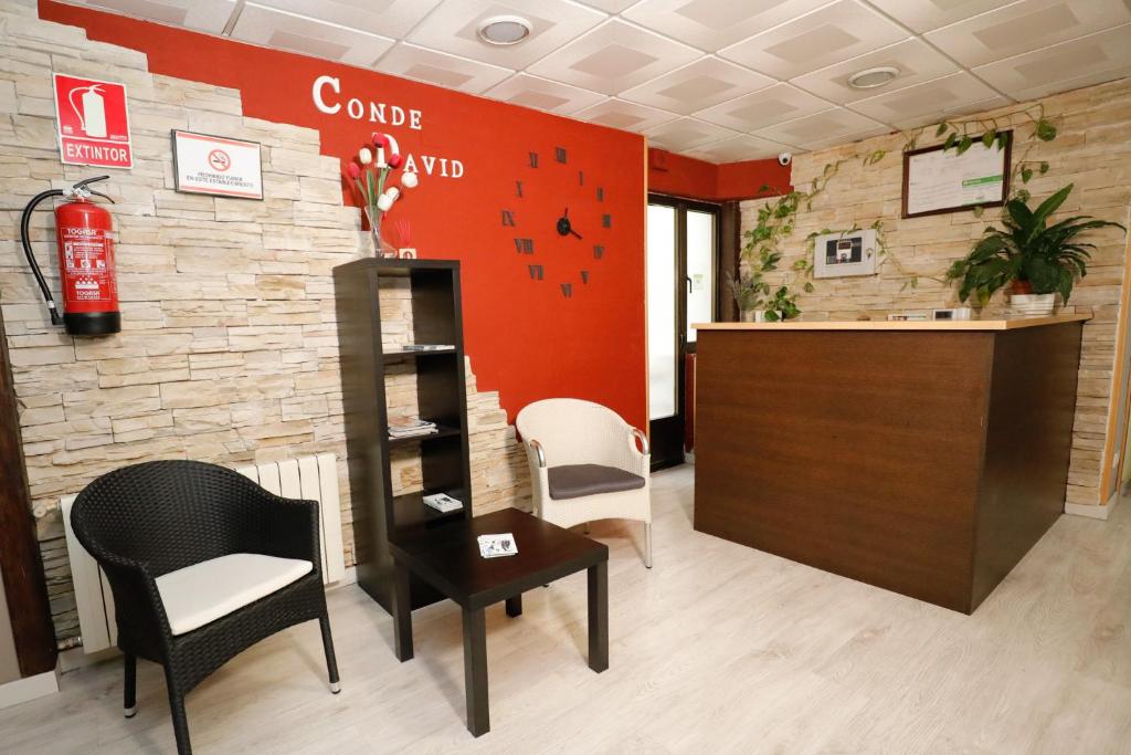 a salon with a counter and chairs and a fire extinguisher at Hostal Conde David in Salamanca