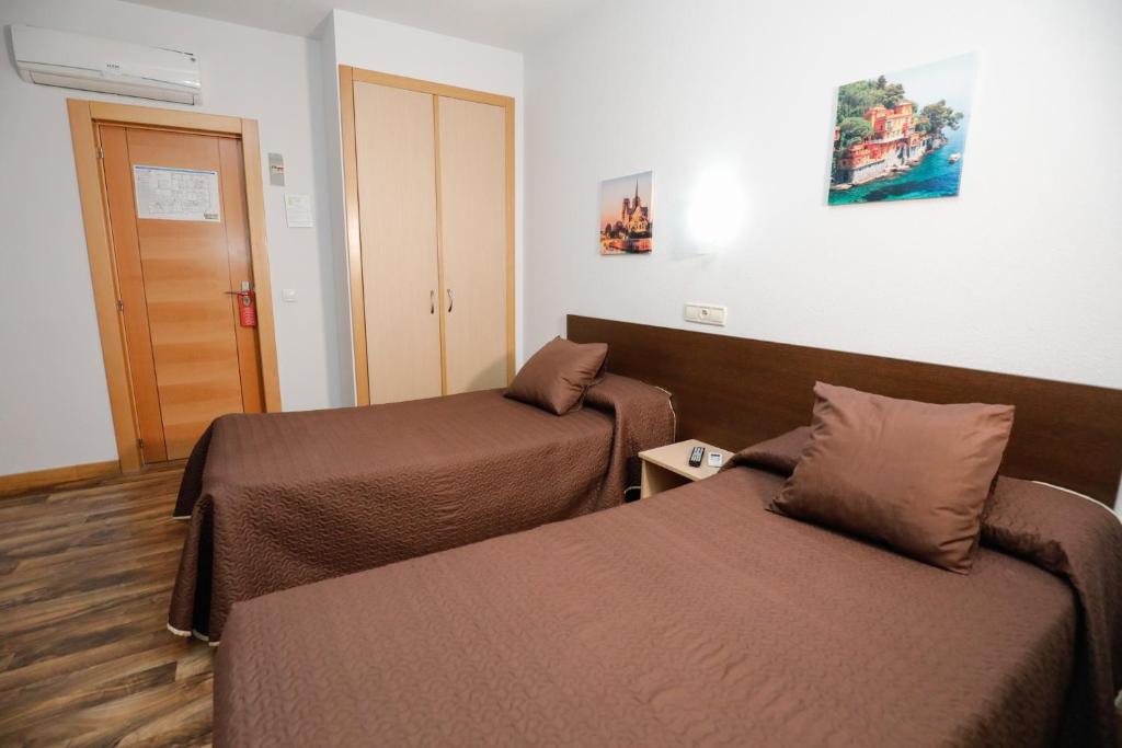 Postel nebo postele na pokoji v ubytování Hostal Conde David