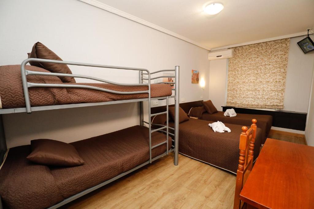 Postel nebo postele na pokoji v ubytování Hostal Conde David
