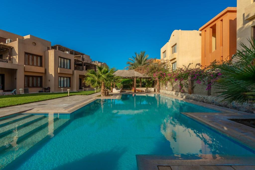 a swimming pool in front of some buildings at Beautiful Cosy 3 bedroom townhouse in South Marina in Hurghada