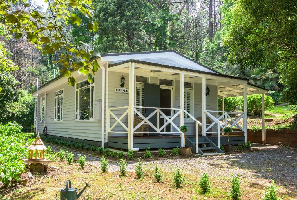a tiny house in the woods with a porch at Franklin - An Escape to the Country in Sassafras