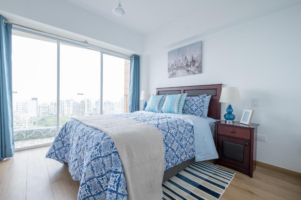 a bedroom with a bed and a large window at GLOBALSTAY - Exclusive Modern Barranco Apartments in Lima