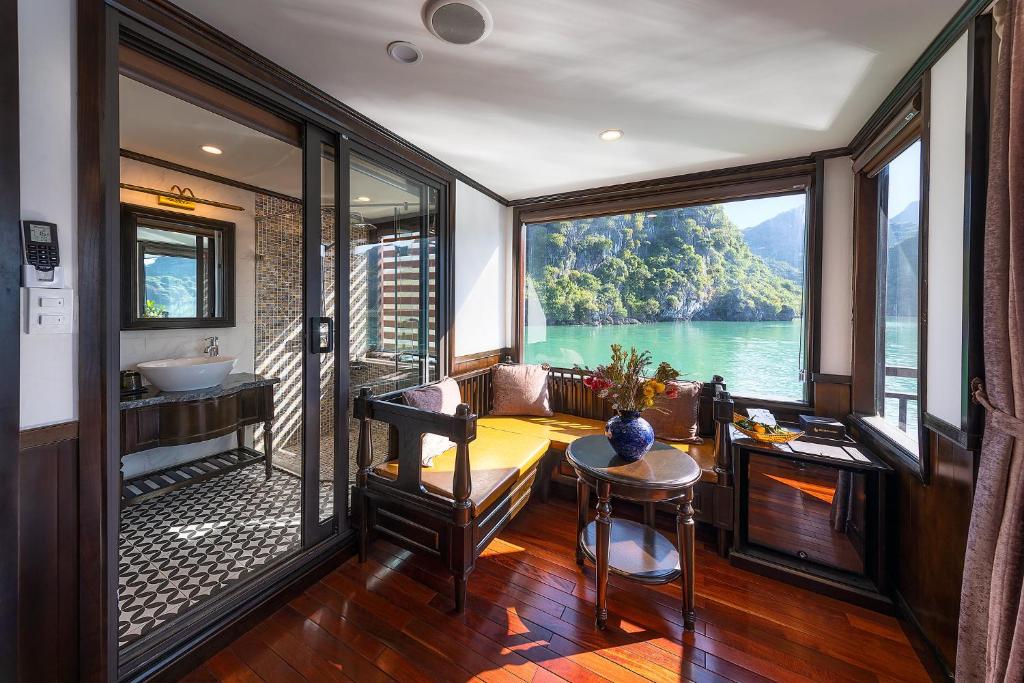 a room with a balcony with a view of the water at Sena Cruises - Wonder On Lan Ha Bay in Ha Long