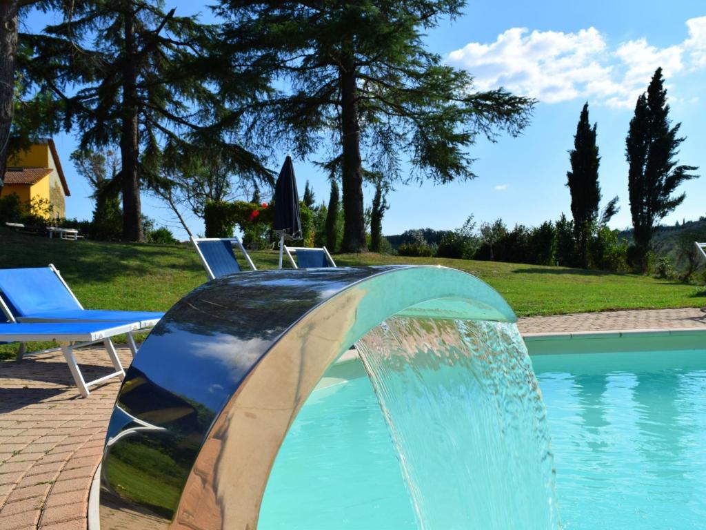 a water fountain in a swimming pool at Farmhouse in Vinci with Swimming Pool Terrace Garden BBQ in Vinci