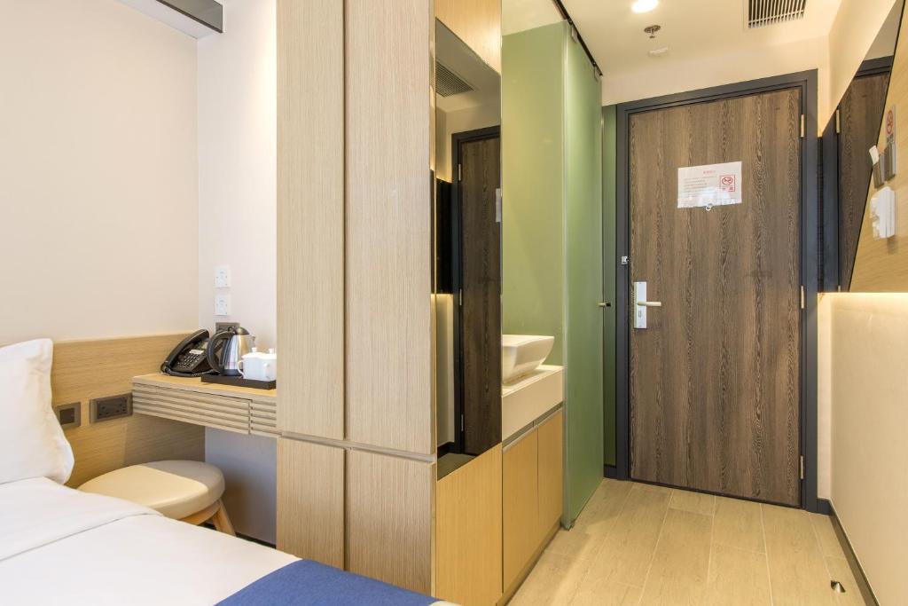 A bed or beds in a room at Lumine Hotel